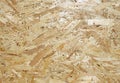 OSB is building material from wooden panel made from of pressed sandy brown wood shavings Royalty Free Stock Photo