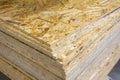 OSB - Oriented strand board. Stacked OSB sheets. Sheet material for the construction of frame houses Royalty Free Stock Photo