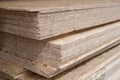 OSB sheets are stacked in a hardware store. The building material is wood. Royalty Free Stock Photo