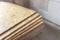 OSB slab building material made from reborn sawdust. They are stacked. Close-up