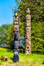 The `Oscar Maltipi Totem Pole` and `Beaver Crest Totem Pole` in Stanley Park. Royalty Free Stock Photo