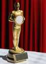 Gold statuette award red curtain