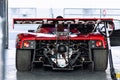 Oschersleben, Germany, April 9, 2023: Tail back view of red racing supercar sport Pagani Zonda Motorsport Arena garage