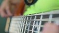 Oscillation of the thickest string of the bass guitar. Close up. Soft focus