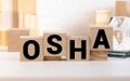 OSHA Occupational Safety and Health Administration. Safety first work background on a wooden cubes