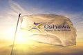 Oshawa of Ontario of Canada flag waving on the top sunrise mist fog