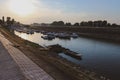 Anchored boats at Drava river in the biggest city in eastern Croatia at sunset Royalty Free Stock Photo