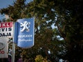 OSIJEK, CROATIA - SEPTEMBER 21, 2023: Peugeot Motocycles logo on an sign of a scooter & bike dealership. Peugeot Motocycles is the