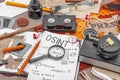 OSINT-themed creative workspace with vintage tools, handwritten notes, and press elements Royalty Free Stock Photo