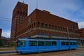 Oslo town hall with iconic blue tram in the foreground Royalty Free Stock Photo