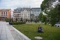 Oslo, Norway-August 1, 2013: a Man rests after work on the Eidsvoll Plass lawn Eidsvoll square is a square and Park located West