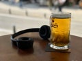 OSLO, NORWAY - CIRCA JULY 2015: a glass of Carlsberg beer with Headphone, brewed in Denmark.