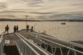 Oslo, Norway, Europe - sunset seen from Aker Bigge; people on a pier. Royalty Free Stock Photo