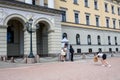 OSLO, NORWAY Ã¢â¬â JULY 11, 2022: Oslo, Norwegian Royal Palace, family taking picture with palace guard outside front entrance