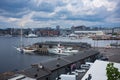Aerial view of Oslo Fjord and commercial boats anchored at nearby docks with the city skyline in the background during a cloudy Royalty Free Stock Photo
