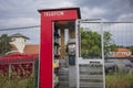 A telephone booth serves as. a Little Free Library located near the Viking Ship Museum, shown here during an overcast summer