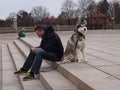 Oslo, Norway - 17 march 2014: norwegian guy walking his beautiful husky dog