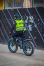 OSLO, NORWAY - MARCH, 26, 2018: Outdoor view of police man riding a bycicle in the sreets of Oslo city Royalty Free Stock Photo