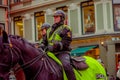 OSLO, NORWAY - MARCH, 26, 2018: Outdoor view of police woman on horse in the sreets of Oslo city Royalty Free Stock Photo