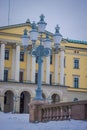 OSLO, NORWAY - MARCH, 26, 2018: Outdoor view of public park lantern with a Royal Palace behind in Oslo
