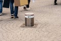 Retractable street security pole preventing cars from entering a pedestrian area..