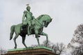 Oslo royal palace monument of king karl johan with bird on head, view from parkway alley boulevard avenue with autumn leaves, nor Royalty Free Stock Photo