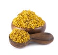 Osmanthus tea in wooden bowl and spoon, isolated on white background. Dry flowers of Osmanthus fragrans.