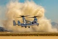 Osprey aircraft kicking up dust upon landing at landing zone