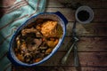 Ossobuco in cooking sauce with carrot, onion, bell pepper and mushrooms accompanied with sweet potato puree in a vintage a plate, Royalty Free Stock Photo