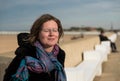 Ostend, West Flanders, Belgium-Attractive white woman with glasses and eyes closed relaxing at the Belgian seaside