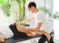 Osteopath doing a tensor fasciae latae treatment