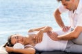 Osteopath manipulating female hip outdoor.