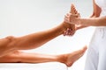 Osteopath massaging female foot. Royalty Free Stock Photo