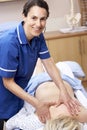 Osteopath treating female client Royalty Free Stock Photo