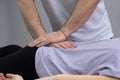 The osteopath works with the coccyx. The work process of a manual therapist. The patient lies on the couch. The doctor