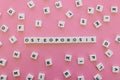 Osteoporosis word made of square letter word on pink background.