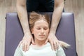 Ostheopatic treatment of a girl patient using CST gentle hands-on technique, central nervous system tension relieve