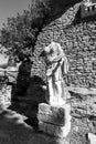 Black and white photo of roman statue in ruins in front of an Ancient OstiaÂ´s building Royalty Free Stock Photo