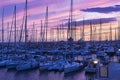 Blue hour at sunset in harbor in Rome with amazing blue sky with pastel-colored colors and orange reflections between sails masts Royalty Free Stock Photo