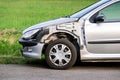 A detail of a frontal part of silver Peugeot 206 car damaged in traffic accident with missing left front fender Royalty Free Stock Photo