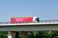 Fast driving truck of Polish Spedycja Pawbud transportation company on a bridge with motion blur effect Royalty Free Stock Photo