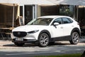 Mazda CX-30 compact crossover in white colour parking in front of restaurant