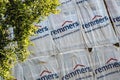 The cover with the Remmers company logo on a scaffolding on a building during the reconstruction of a facade. The firm produces