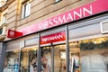 The entrance to the Rossmann drugstore shop in Ostrava with red banner and logo of the company