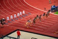 Female Sprinters Competing in 100m Hurdles Race: Track and Field Athletes Navigate Obstacles for