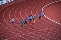 Focused Runners in Action: Men Participate in 200m Sprint at Track and Field Championship for