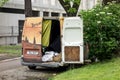 A robbed Ford Transit van left on a street with wrenched doors as a sign of vandalism. It is used by homeless people as a home