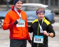 Ostrava, Czechia - 02.04.2023: Runners celebrating with their medals after amateur winter run race in the city. Innogy