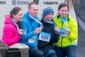 Ostrava, Czechia - 02.04.2023: Runners celebrating with their medals after amateur winter run race in the city. Innogy