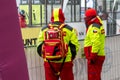 Ostrava, Czechia - 02.04.2023: Two male security medics in bright green reflective vests overlooking run race